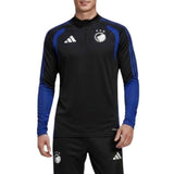 A man modeling a black and blue Adidas x FC Copenhagen training top and matching pants against a white background.