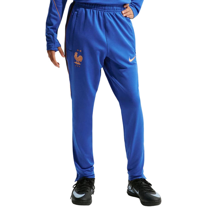 Blue Nike tracksuit pants with elastic waistband and embroidered logo
