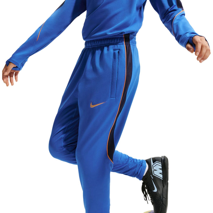 Blue Nike x France track pants with side pockets and contrasting gold stripes