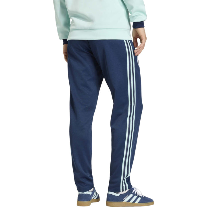 Navy blue Adidas track pants with three white stripes on sides and elastic waistband