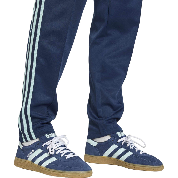 Navy blue Adidas Gazelle sneakers with white stripes and gum rubber sole