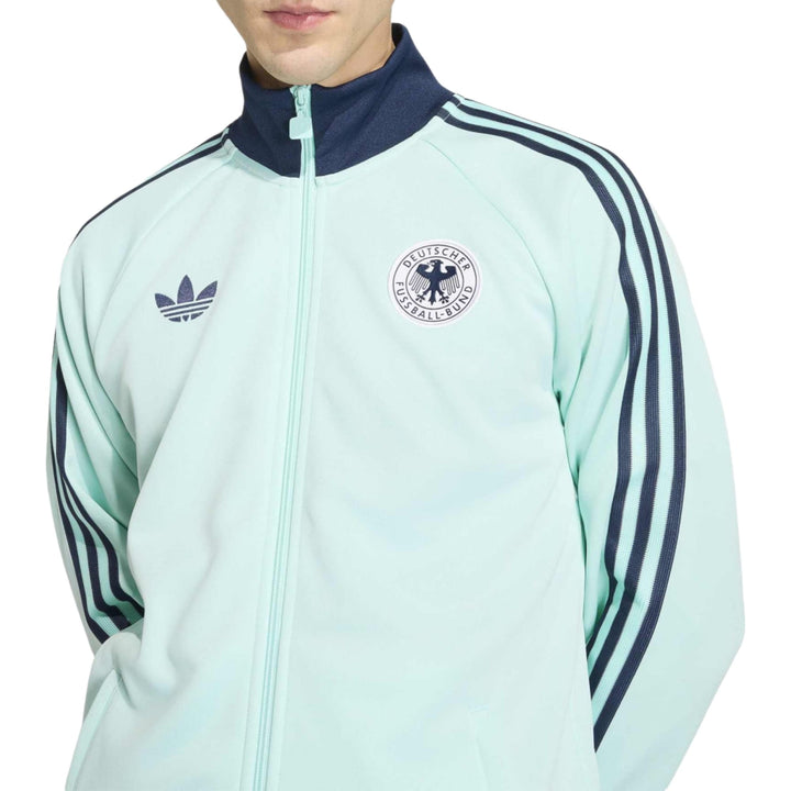 Light blue Adidas track jacket with navy accents and three stripes on sleeves