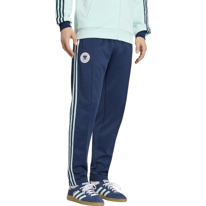 Men's navy blue athletic pants with three white stripes and logo detail