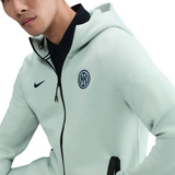 Man wearing an Inter Milan tech fleece tracksuit 2025 in light color with the logo displayed