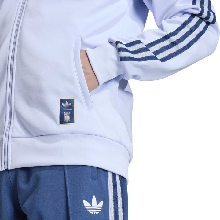 White Adidas track jacket with blue stripes and logo on the chest pocket