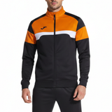 Front view of a man wearing the Joma Danubio III tracksuit in black/orange, featuring a color-contrast jacket and embroidered Joma logo.