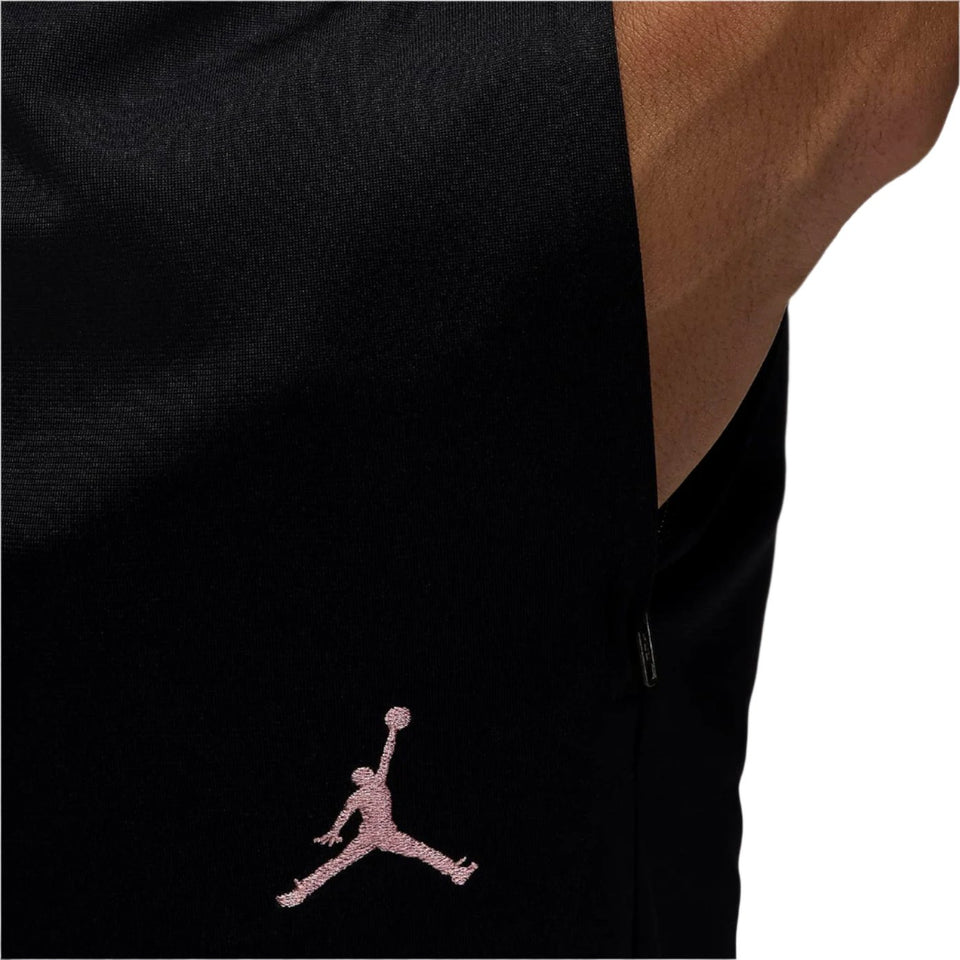 Close-up of black PSG Champions League tracksuit pants with pink Jumpman logo embroidery