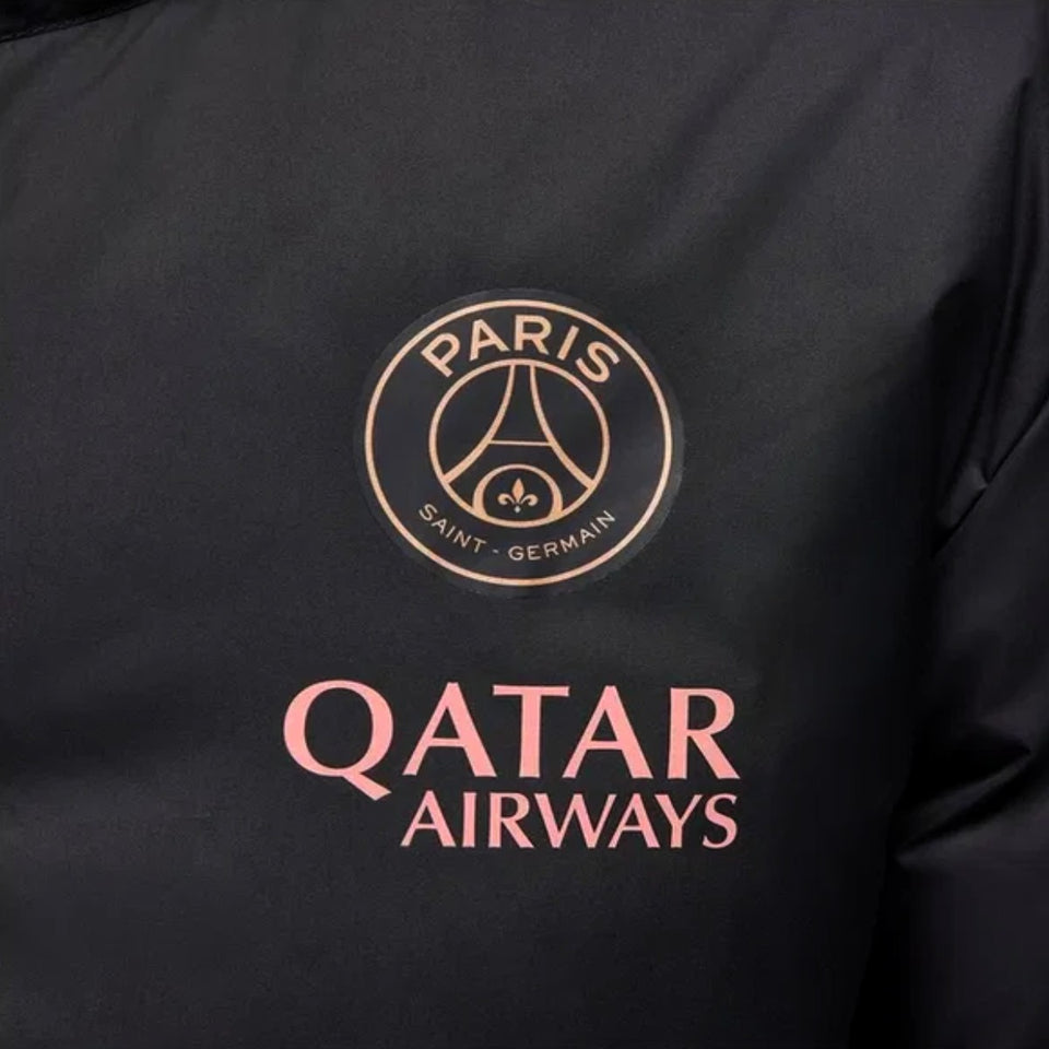 Close-up of Jordan PSG UCL parka jacket featuring Paris Saint-Germain logo and Qatar Airways branding