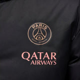 Close-up of Jordan PSG UCL parka jacket featuring Paris Saint-Germain logo and Qatar Airways branding