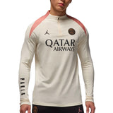 Jordan PSG UCL training top 2024 in cream color with pink accents and Qatar Airways logo