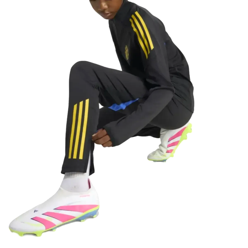 Kids Manchester United UCL training tracksuit 2025 in black with yellow stripes, perfect for young soccer fans