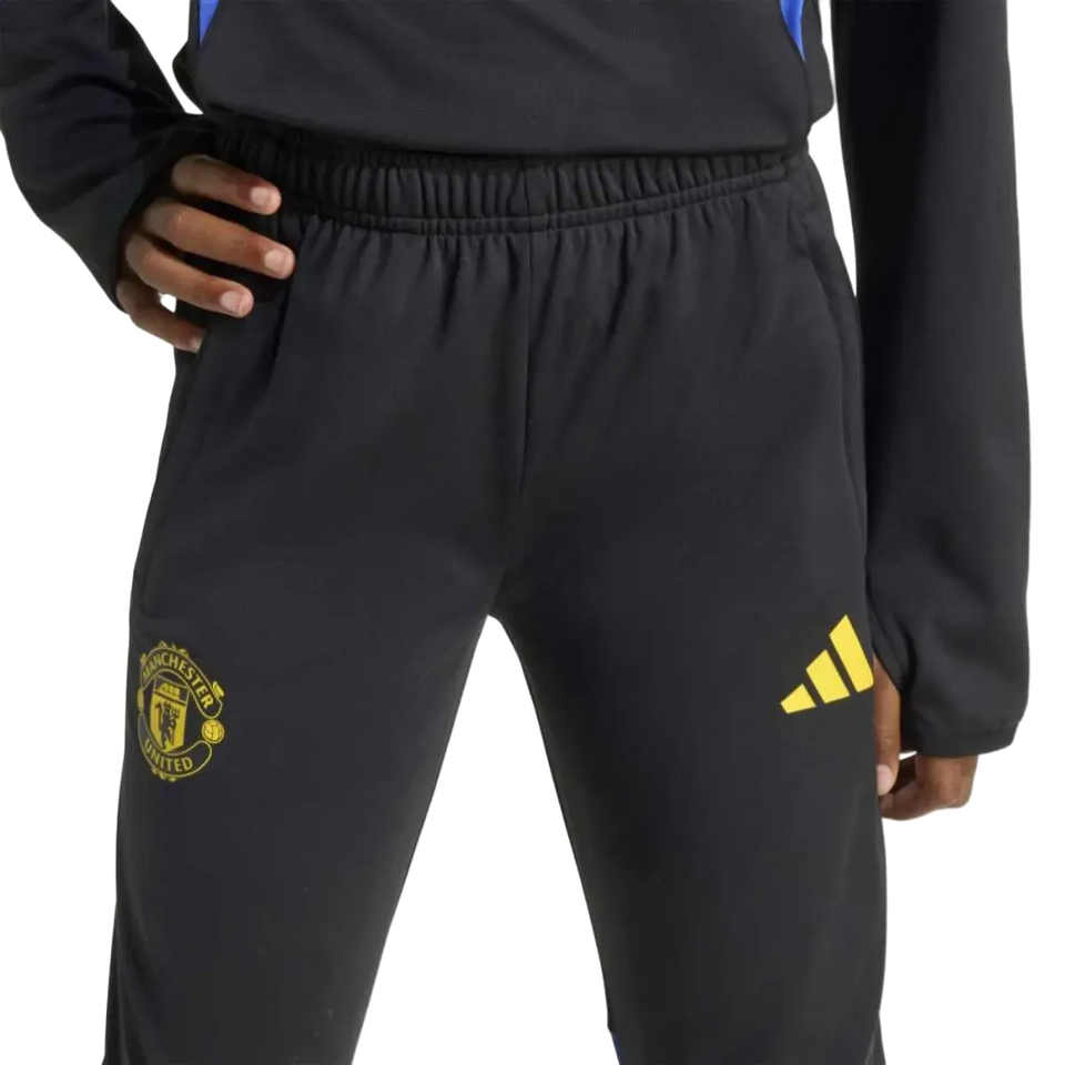 Kids Manchester United UCL training tracksuit 2025 with black pants and yellow logo for young fans