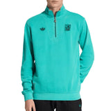 Teal Adidas x Liverpool FC pullover with brand logo on a white background