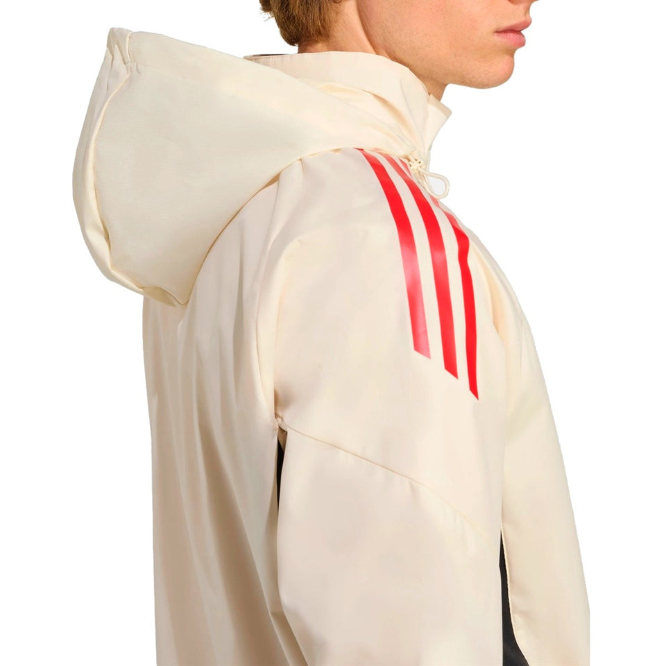 Man wearing a Liverpool FC training rain jacket 2025 with a stylish hood and red stripes on SoccerTracksuits.com