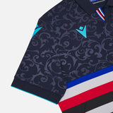 Close up navy patterned Macron Sampdoria soccer jersey sleeve with turquoise logo and tricolor chest stripes
