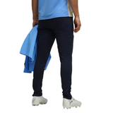 Back view of a soccer player wearing the Manchester City training tracksuit 2025 26 with navy pants and a light blue top