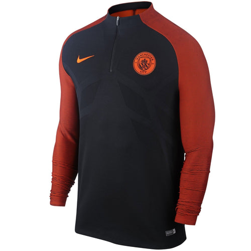 Manchester City Vaporknit training top in black and orange for optimal performance and comfort on SoccerTracksuits.com