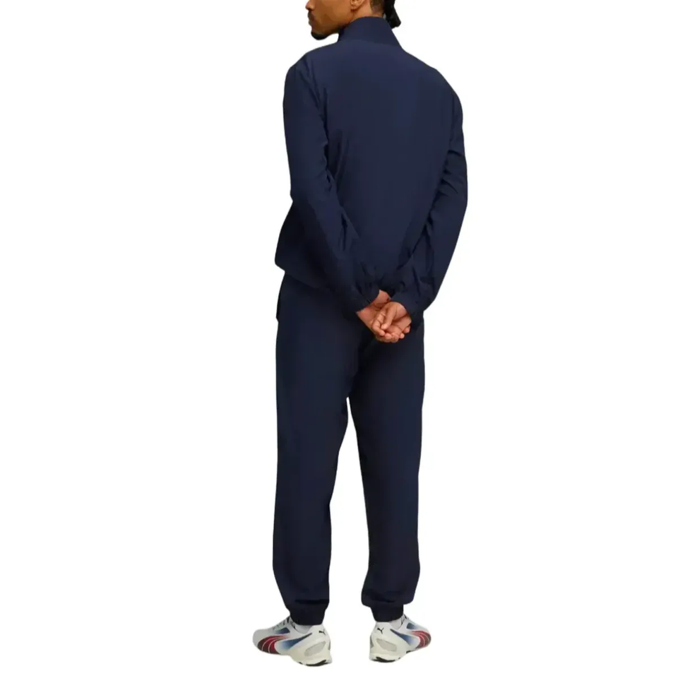Back view of a man in a navy Manchester City woven tracksuit 2025 26, perfect for training and casual wear