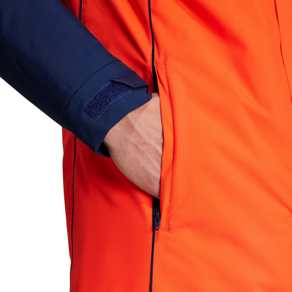 Manchester United Adidas parka jacket featuring secure side pockets and adjustable cuffs in vibrant orange