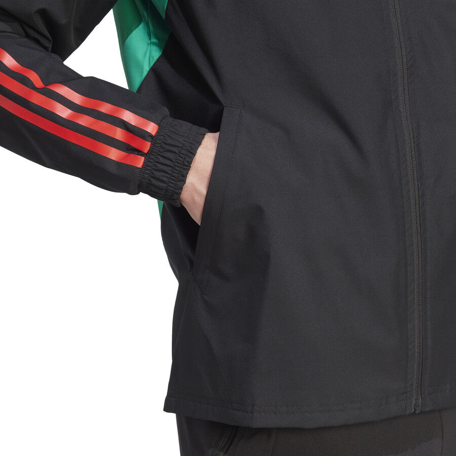 Close-up of Manchester United black rain jacket 2023 with red stripes and side pocket detail