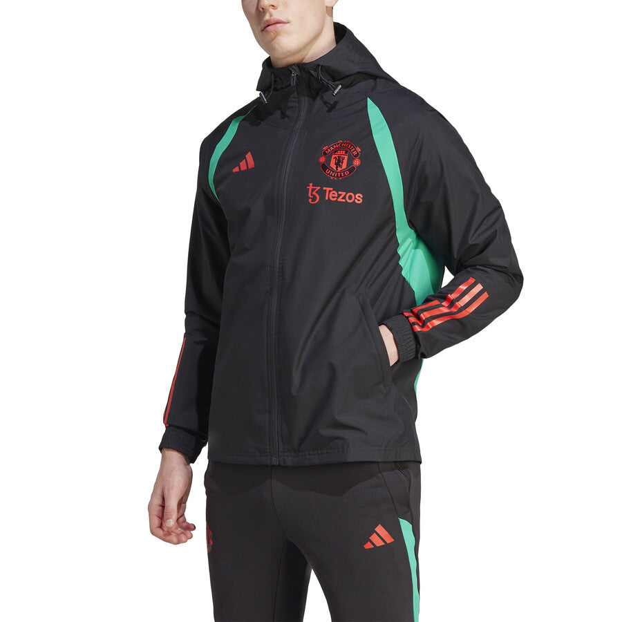 Manchester United black rain jacket 2023 with green accents and team logo on the chest