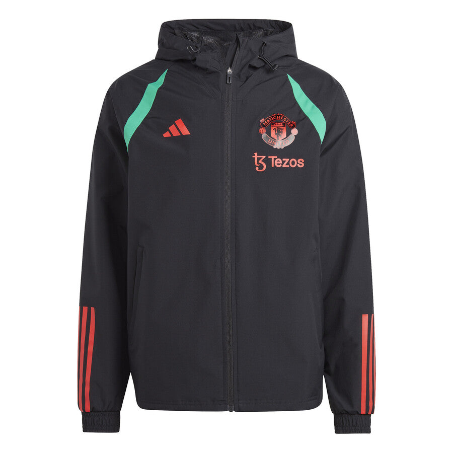 Manchester United black rain jacket 2023 with teal accents and red logos on SoccerTracksuits.com