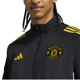 Manchester United black UCL tracksuit 2025 featuring a zip-up jacket with logo and yellow accents