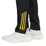 Manchester United black UCL tracksuit 2025 featuring stylish black pants with yellow stripes