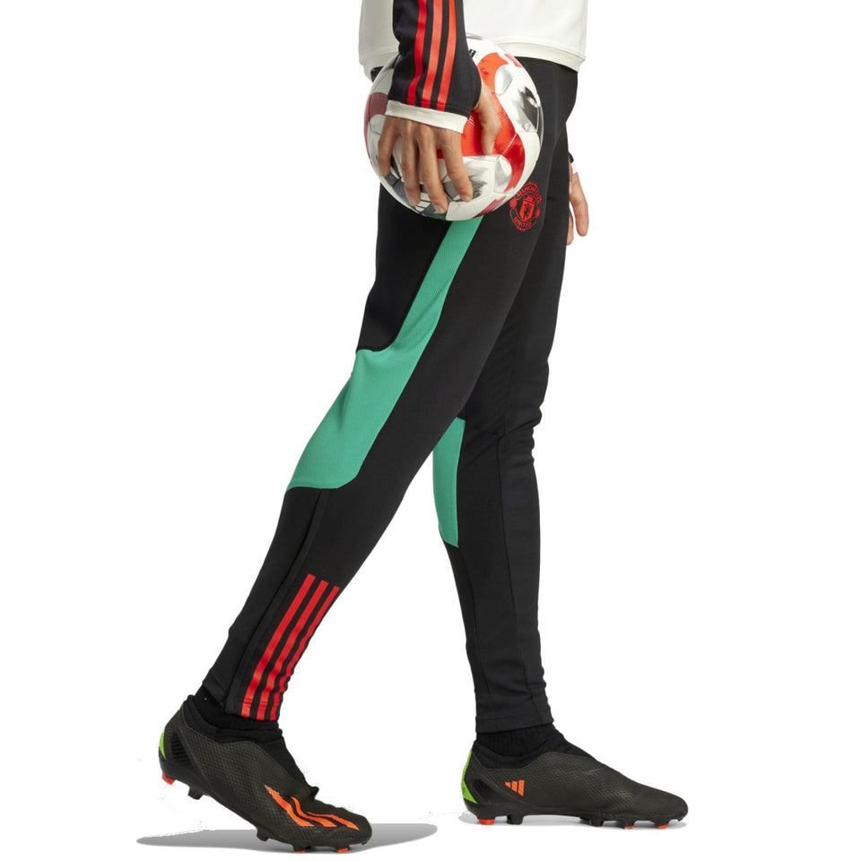 Manchester United hooded tracksuit 2024 featuring stylish black pants with green accents and logo