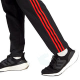 Manchester United presentation tracksuit 2023 featuring stylish black pants with red stripes