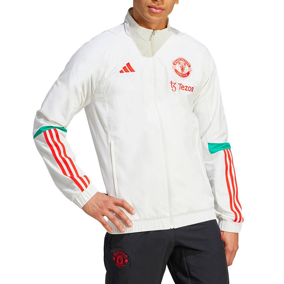 Manchester United presentation tracksuit 2023 featuring a white jacket and black pants with iconic branding