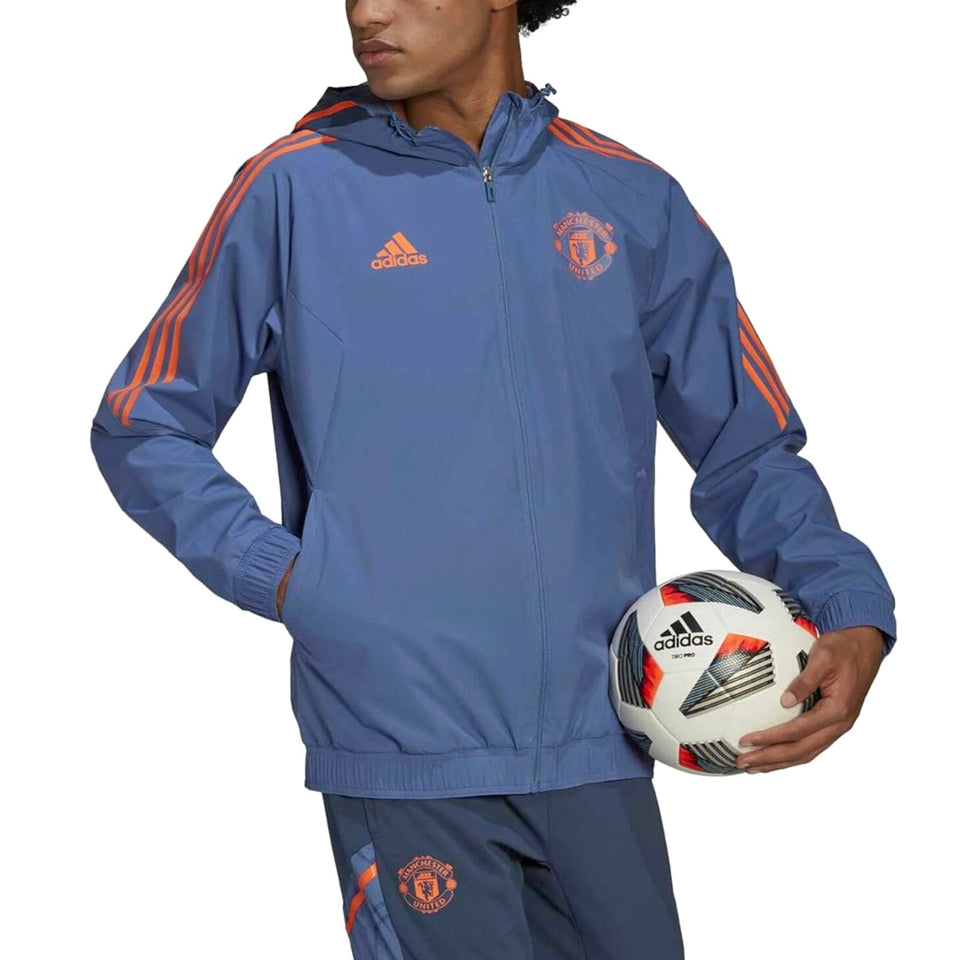 Manchester United training rain jacket 2022 in blue with orange accents and hood, designed for soccer practice