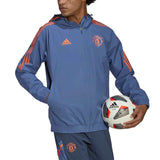 Manchester United training rain jacket 2022 in blue with orange accents and hood, designed for soccer practice