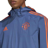 Manchester United training rain jacket 2022 in blue with orange accents and logo for fans