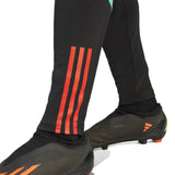Black Manchester United training tracksuit 2023 24 featuring red detailing on the legs for athletes