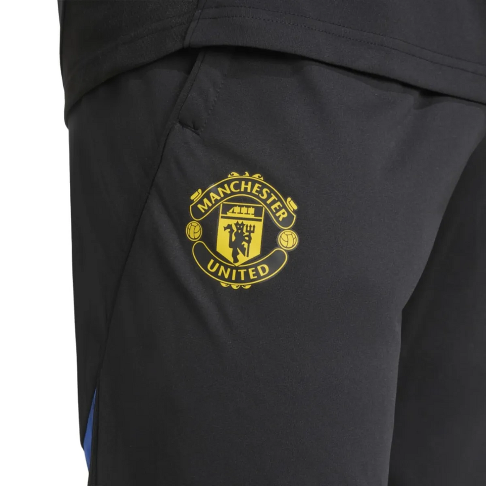 Manchester United UCL training tracksuit 2025 26 featuring the iconic club logo on pants