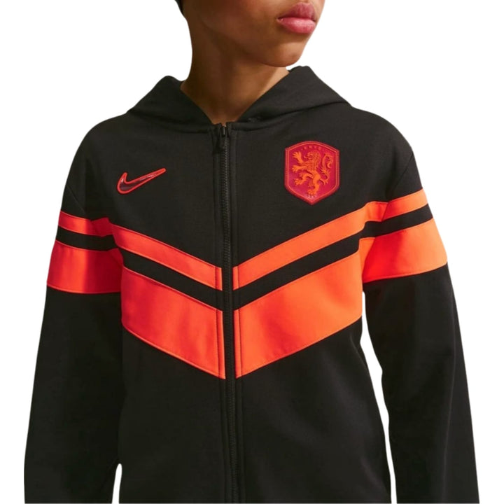 Kids Netherlands 2026/27 casual presentation soccer tracksuit in black and orange with Nike logo and crest