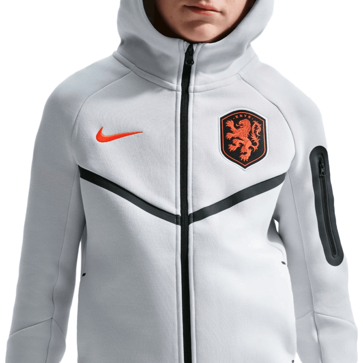 White Nike Tech Fllece hoodie with orange logo and Netherlands crest, featuring zippered pocket on sleeve.