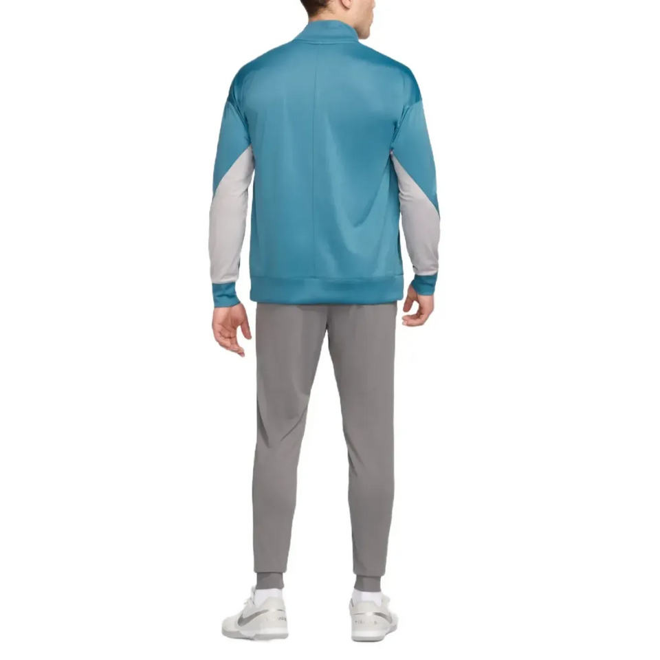 Back view of man wearing Atletico Madrid soccer tracksuit for sale with blue and gray colors