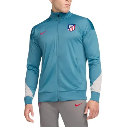 Atletico Madrid soccer tracksuit for sale featuring blue zip-up jacket with club crest and grey pants