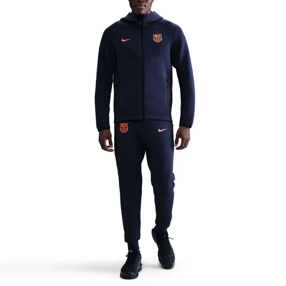 Nike Barcelona tech fleece tracksuit UCL in navy, featuring the iconic club logo and sleek design on SoccerTracksuits.com