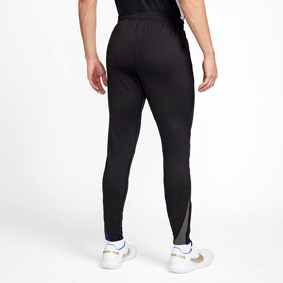 Back view of black Nike Barcelona training tracksuit pants worn with white sneakers