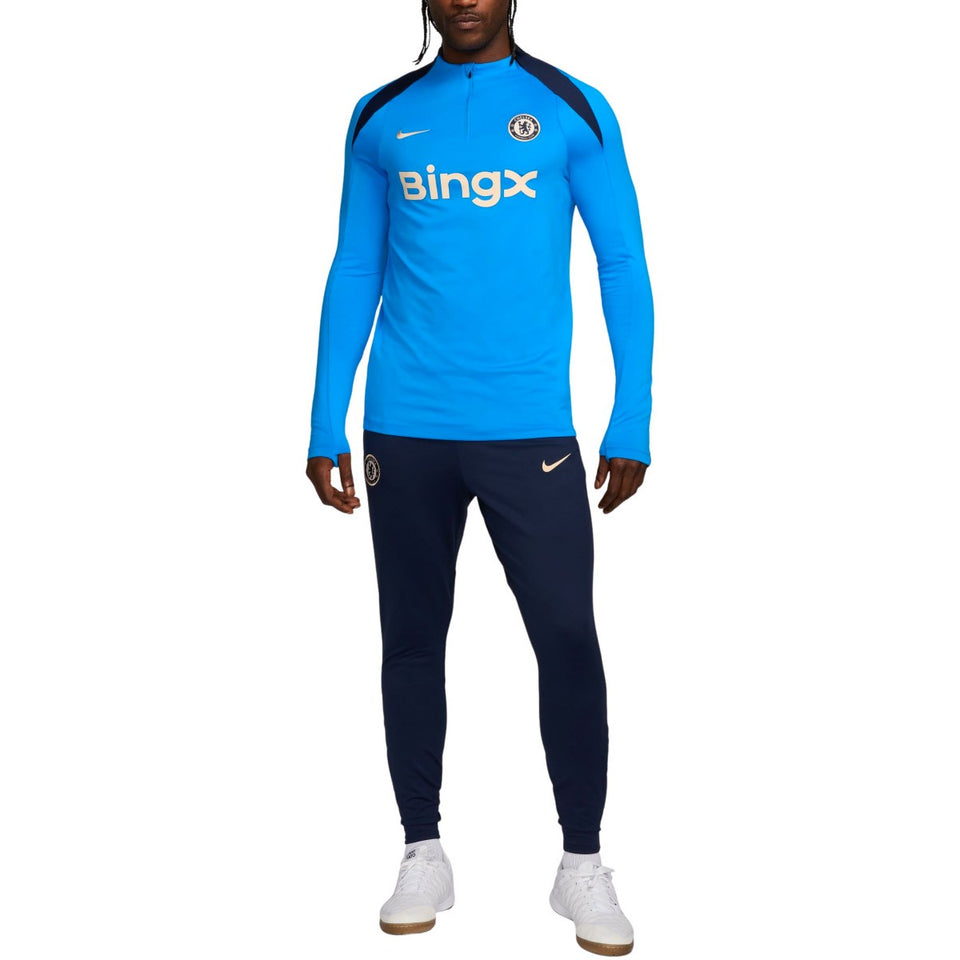 Chelsea FC 2024 training tracksuit with blue top and navy pants modeled for soccer practice