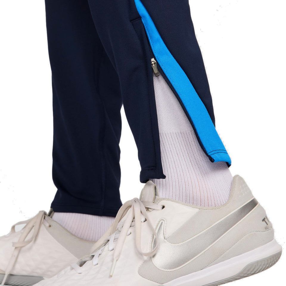 Close-up of Chelsea FC 2024 training tracksuit navy pants with blue stripe and zipper detail near ankle