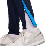 Close-up of Chelsea FC 2024 training tracksuit navy pants with blue stripe and zipper detail near ankle