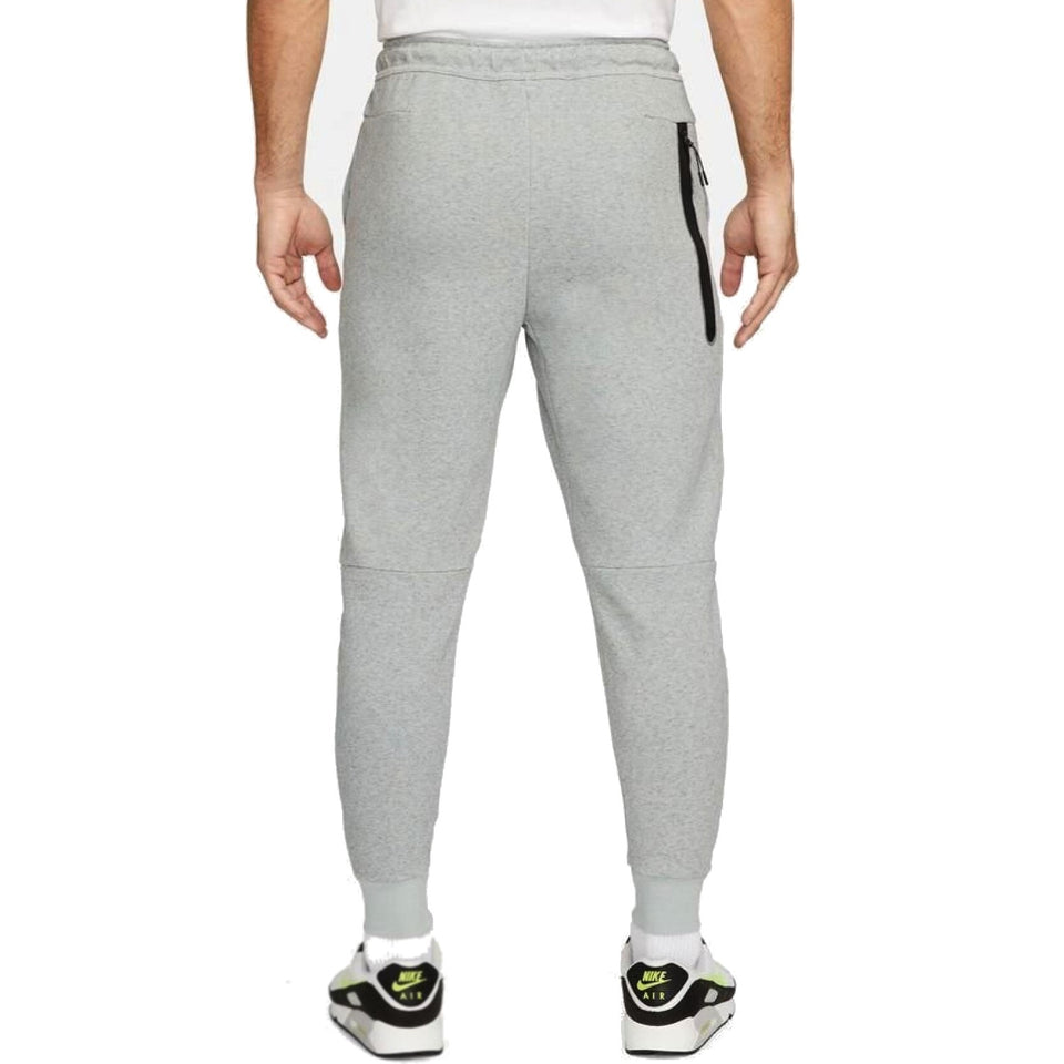 Back view of grey Chelsea FC tech fleece tracksuit grey pants with zip pocket worn by model