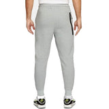 Back view of grey Chelsea FC tech fleece tracksuit grey pants with zip pocket worn by model