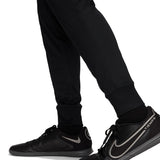 Close-up of black pants and black Nike Tiempo soccer shoes with Nike Chelsea UCL presentation suit