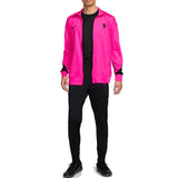 Men wearing Nike Chelsea UCL presentation suit with bright pink jacket and black pants