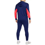 Back view of man wearing Croatia soccer tracksuit 2024 25 in navy blue with red sleeves and hood